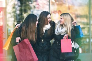 Holiday shopping girls in the street with bags