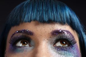 Portrait of Beautiful Woman with Glitter Makeup.