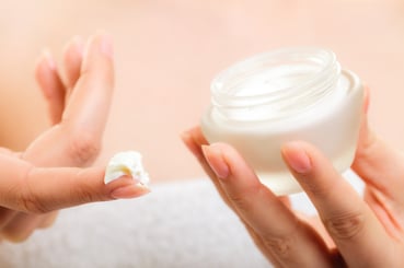 Skin care. Moisturizing cream in female hands