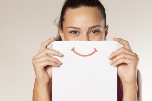 happy and smiling girl with a smile painted on paper