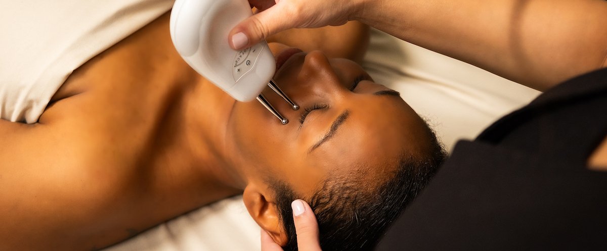 Woman in spa receiving face treatment